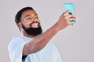 Image showing Happy black man, selfie and photography for social media, vlog or networking against a grey studio background. African male person smile for photo, memory or online communication and picture post