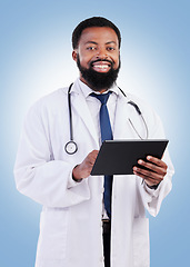 Image showing Healthcare, portrait and tablet and a black man doctor in studio on a blue background for cardiology research. Medical, innovation and a male medicine professional searching for information online