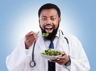 Image showing Doctor studio portrait, black man and salad to lose weight, vegan healthcare diet or healthy food benefits for clean eating. Green lettuce bowl, hungry or African male nutritionist on blue background