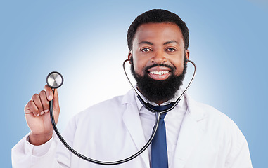 Image showing Portrait, stethoscope and man doctor in studio with cardiovascular, exam or consultation on blue background. Heart, health and African male surgeon with medical tool for heartbeat and breathing