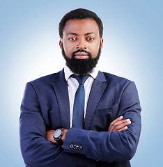 Image showing Serious, crossed arms and portrait of businessman in a studio with success, confidence and leadership. Pride, professional and headshot of a young, male and African lawyer isolated by blue background