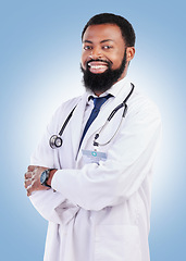 Image showing Black man, doctor and portrait with arms crossed in studio or happy medical expert or healthcare worker on blue background. African surgeon, smile and confidence in medicine or research in hospital