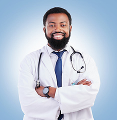 Image showing Doctor, black man and portrait with arms crossed in studio or happy medical expert or healthcare worker on blue background. African surgeon, smile and confidence in medicine or research in hospital