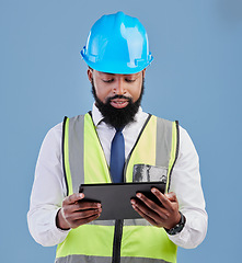 Image showing Black man, architect and tablet for construction inspection or planning against a blue studio background. African male person, engineer or contractor working on technology for industrial architecture