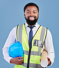 Image showing Happy black man, portrait and architect with blueprint for construction against a blue studio background. African male person, engineer or contractor smile with hard hat or documents for project plan