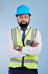 Image showing Engineering, man or serious portrait with arms crossed in studio in development, building construction or industrial technician. Black male architect, contractor or project manager on blue background