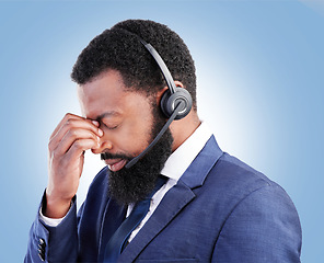 Image showing Customer service face, studio black man and depressed over tech support fail, insurance agent crisis or call center burnout. Mental health risk, e commerce or African person crying on blue background