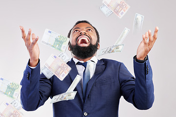 Image showing Money, rain and happy black man in studio for savings, growth or cashback bonus on white background, Cash, shower and African winner with investment, success or financial freedom award celebration