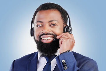 Image showing Customer support headset, happy portrait and black man consulting for call center advice, telecom services or sales pitch. E commerce, studio face and African person talking on mic on blue background