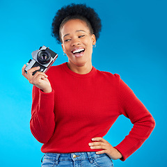 Image showing Photographer woman, thinking and camera in studio for photoshoot, memory and magazine by blue background. Young journalist girl, retro tech and lens for paparazzi, newspaper or content creator job