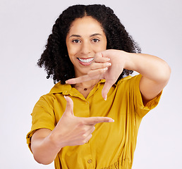 Image showing Happy woman, portrait and frame hands for photography, picture or creativity against a white studio background. Female person or photographer smile framing with gesture, shape or icon in photo moment