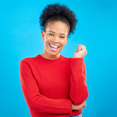 Image showing Studio, portrait and happy black woman with natural beauty and confidence with afro hairstyle and casual fashion. Smile, African girl and laughing with a mindset of happiness on blue background