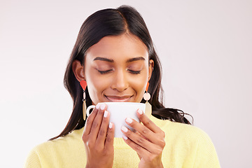 Image showing Woman, coffee and smile in studio with thinking, smell and aroma with fashion, relax or drink by white background. Gen z girl, happy student and memory with cup for coco, matcha or espresso with idea