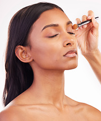 Image showing Beauty, makeup and brush on face of woman in studio for cosmetics, foundation and eyeshadow. Salon, self care and glow with female model on white background for application, powder and facial