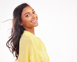 Image showing Hair, wind and Indian woman in studio portrait with white background for fashion, makeup or confidence with natural beauty. Face, smile and young model with freedom and happiness with space or mockup