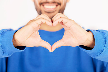 Image showing Closeup, heart and hands of man in studio, white background and care for kindness, donation and charity. Happy model with finger shape for love icon, thank you and emoji in support of valentines day