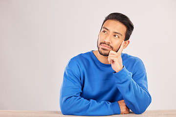 Image showing Why, thinking and space with man and idea in studio for confused, brainstorming and question. Doubt, solution and choice with asian person on white background for decision, opportunity and mockup