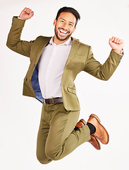 Image showing Winner, business man and jump for success, celebration and yes in stock market and bonus on white background. Wow, excited portrait and corporate asian person for financial goals in air and studio