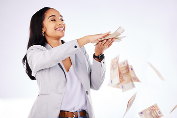 Image showing Money, rain and a woman lottery winner in studio on a white background in celebration of a bonus or promotion. Cash, finance and payment with a happy young female excited about investment growth