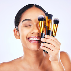 Image showing Makeup brush, beauty and cosmetics of a happy woman in studio for skincare, self care and cosmetology. Skin glow, shine and wellness of a female model with facial application tools for foundation