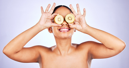 Image showing Woman, kiwi fruit and natural beauty, hands and skin with eco friendly skincare on purple background. Vitamin C, wellness and dermatology with female model, healthy cosmetic care and sustainability