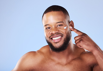 Image showing Beauty, skincare and cream with portrait of black man in studio for sunscreen, cosmetics and spa treatment. Facial, self care and mockup with person on blue background for lotion, wellness and health