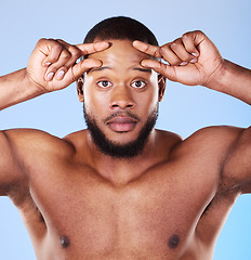 Image showing Skincare, wrinkle and portrait of black man in studio hand on forehead for aging skin check on blue background. Fine lines, anxiety and face of African male model with worry for dermatology problem