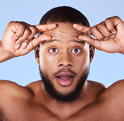 Image showing Aging, anxiety and black man portrait in studio for skin, check and beauty routine on blue background. Skincare face, worry and African male model surprised by fine lines, fail or dermatology problem