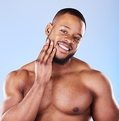 Image showing Skincare, portrait of black man with hand on face, studio and luxury skin care morning routine. Dermatology, spa cosmetics and facial beauty glow for wellness, happy model isolated on blue background