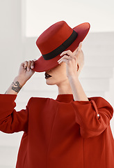 Image showing Woman, red hat and mystery with fashion, makeup and beauty with aesthetic, vintage style or character. Girl, model and retro clothes with cosmetics, art and hidden face with suit with creativity