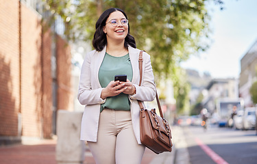 Image showing Walking, phone and a woman outdoor in a city with communication, internet connection and app. Happy, professional and business person on urban road with smartphone for chat or social media on travel