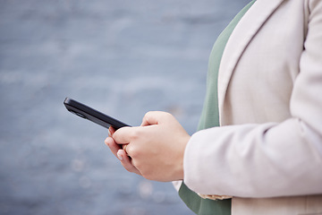 Image showing Hands, phone and a person outdoor with communication, internet connection and mobile app. Closeup of a business woman, urban town and a smartphone while typing a message or chat on social media