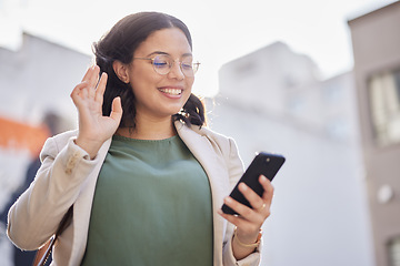 Image showing Business, woman and phone with video call in the city and contact with network connection, communication or conversation. Happy, wave and person speaking on mobile or hello, gesture and greeting