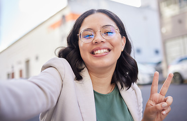 Image showing Business woman, selfie and street with peace sign, smile or glasses for blog, finance career or city. Employee, portrait and happy with icon, memory or photography for profile picture on social media