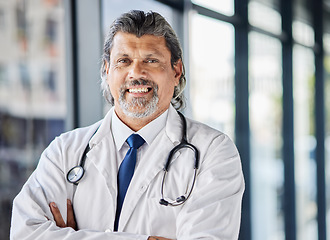 Image showing Doctor, healthcare portrait and arms crossed in clinic or hospital of patient support, leadership or management. Face of senior medical person with professional health services and proud job