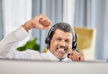 Image showing Call centre, celebrate and a happy man at a computer with success, achievement or bonus win. Mature male consultant or agent with fist for customer service, help desk and crm or telemarketing target