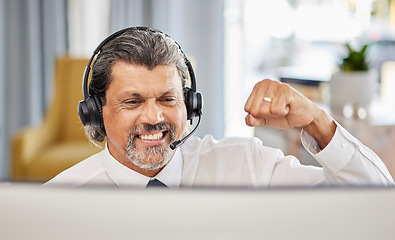 Image showing Call centre, happy and a man at computer to celebrate success, achievement or bonus win. A mature male consultant or agent with a fist for customer service, help desk and crm or telemarketing target