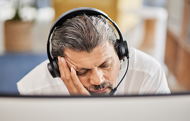 Image showing Exhausted, customer service and male consultant sleeping in his office doing an online consultation. Fatigue, burnout and tired mature man telemarketing agent taking a nap with a headset in workplace