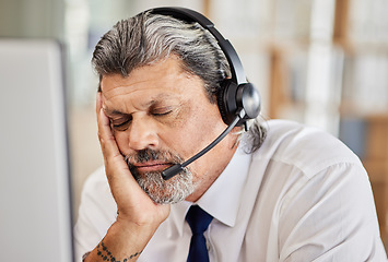 Image showing Tired, call center and male consultant sleeping in his office while doing an online consultation. Exhausted, burnout and mature man telemarketing or customer support agent with a headset in workplace