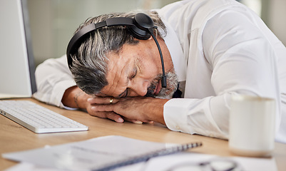 Image showing Tired, customer service and male agent sleeping in his office while doing online consultation. Exhausted, burnout and mature man telemarketing or call center consultant taking a nap in the workplace.