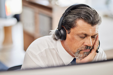 Image showing Fatigue, sleep and male call center consultant in his office while doing online consultation. Exhausted, burnout and tired mature man telemarketing or customer support agent with headset in workplace