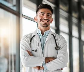 Image showing Crossed arms, confidence and portrait of a male doctor with a stethoscope in a medical hospital. Happy, smile and headshot of a professional young man healthcare worker or surgeon in medicare clinic.