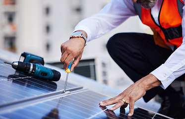 Image showing Solar panels, man hands and tools for engineering maintenance, sustainability development and rooftop, Grid, screwdriver and industrial worker or electrician for eco photovoltaic installation in city