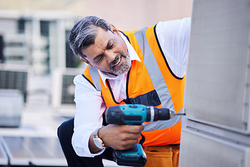 Image showing Solar panels, man and drill for building maintenance, renovation services or upgrade in city. Mature electrician, construction tools and engineering of electrical system, generator or hvac on rooftop