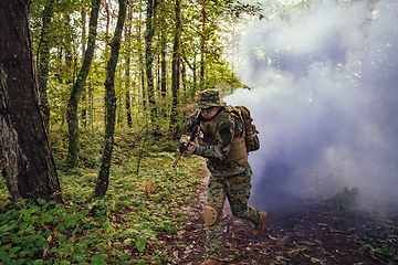 Image showing Battle of the military in the war. Military troops in the smoke