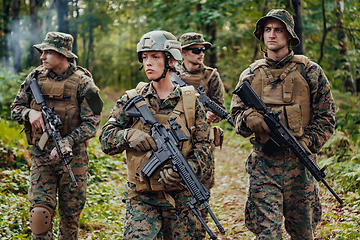 Image showing Modern Warfare Soldiers Squad Running in Tactical Battle Formation Woman as a Team Leader