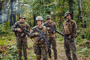 Image showing Modern Warfare Soldiers Squad Running in Tactical Battle Formation Woman as a Team Leader