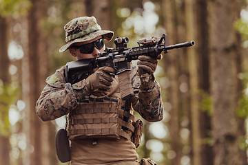 Image showing A modern warfare soldier on war duty in dense and dangerous forest areas. Dangerous military rescue operations