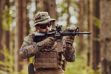 Image showing A modern warfare soldier on war duty in dense and dangerous forest areas. Dangerous military rescue operations