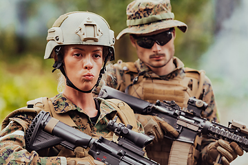 Image showing Modern Warfare Soldiers Squad Running in Tactical Battle Formation Woman as a Team Leader